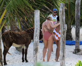Iskra Lawrence in a one piece bathing suit while the beach in Tulum Mexico.