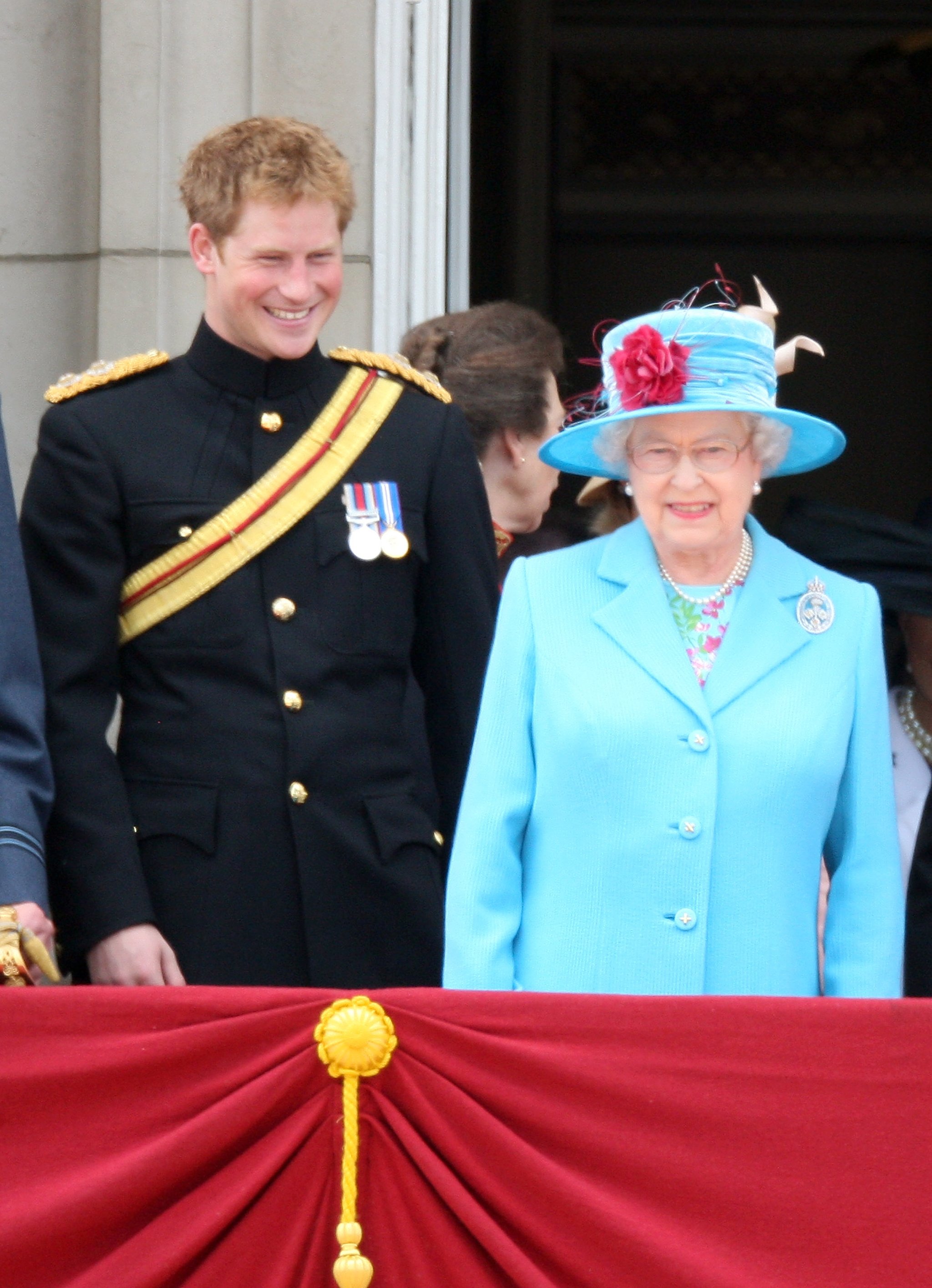 LONDON, ENGLAND - JUNE 13:  HRH Prince Harry, Laughs next to HM Queen Elizabeth II as they look out from the balcony of Buckingham Palace after the Trooping the Colour ceremony on June 13, 2009 in London, England. The ceremony of Trooping the Colour is believed to have first been performed during the reign of King Charles II. In 1748, it was decided that the parade would be used to mark the official birthday of the Sovereign. More than 600 guardsmen and cavalry make up the parade, a celebration of the Sovereign's official birthday, although the Queen's actual birthday is on 21 April.  (Photo by Chris Jackson/Getty Images)