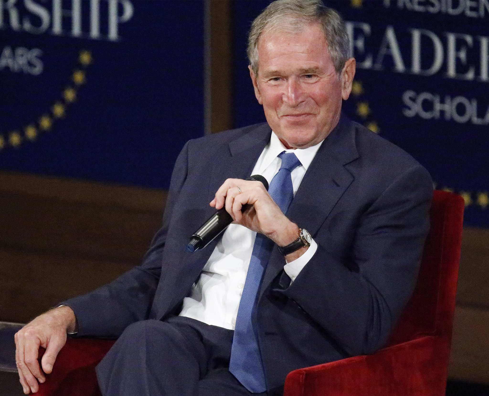 DALLAS, TX - JULY 13: Former U.S. President George W. Bush responds with a smile after making a joke while answering a question at the Presidential Leadership Scholars graduation ceremony at the George W. Bush Institute on July 13, 2017 in Dallas, Texas. The organization brings together leaders from non-profits, the military and public and private sectors for programs in leadership.  (Photo by Stewart  F. House/Getty Images)