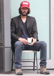 Keanu Reeves enjoys his morning smoking a cigarette while drinking coffee